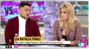 a man and a woman are sitting at a table with the words la batalla final on the bottom