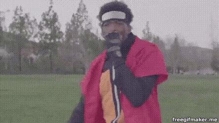 a man in a red costume is standing in a field .