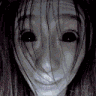 a close up of a scary woman 's face with black eyes and a smile .