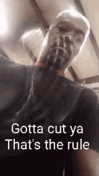 a man with a beard is wearing a black shirt with the words gotta cut ya that 's the rule on it