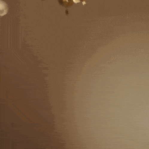 a happy birthday card with gold confetti falling in the background