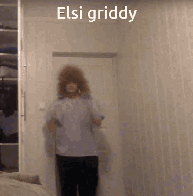 a person standing in a room with the words elsi griddy on the top