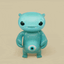 a blue stuffed animal with a big eye and a smile on his face