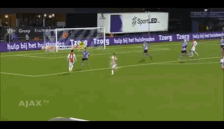a soccer game is being played in front of a sign that says sportled