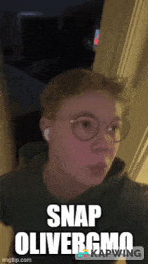 a young man wearing glasses and ear buds is standing in a doorway with the caption snap olivergmo