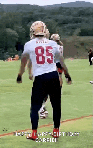 a football player wearing a white jersey with the number 85 on it .