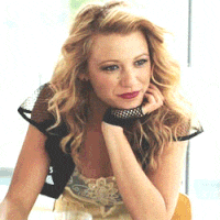 a woman wearing a black jacket and gloves is sitting at a table
