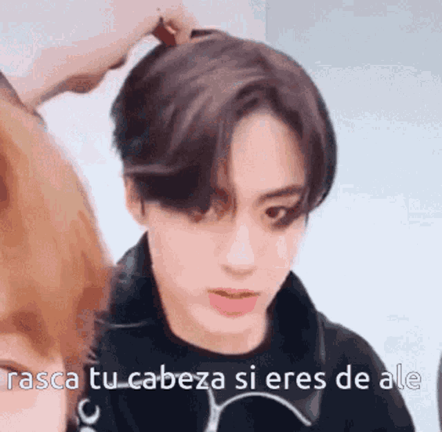 a close up of a person 's face with a caption that says `` rasca tu cabeza si eres de ale ''