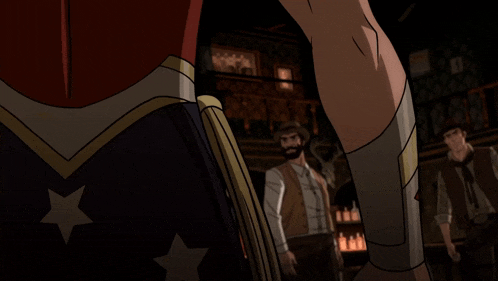 a woman in a wonder woman costume is standing next to two men