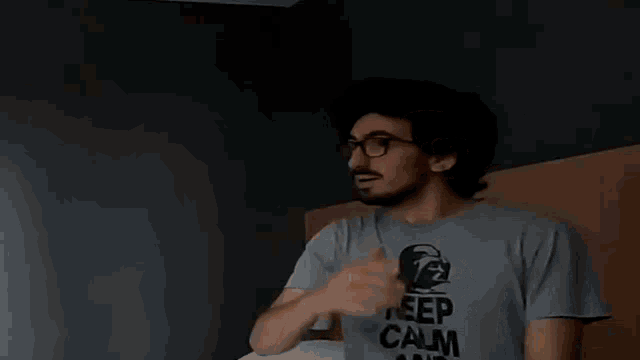 a man wearing a shirt that says " keep calm "