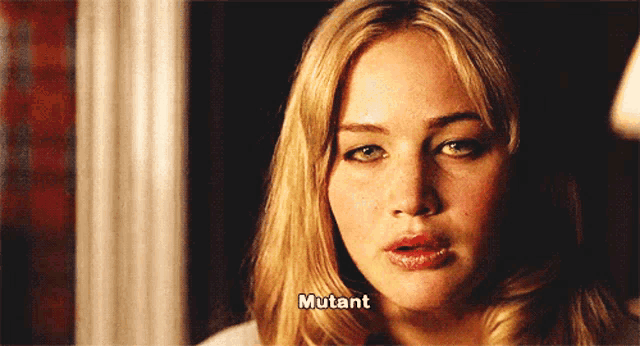 a close up of a woman 's face with the word mutant written on it