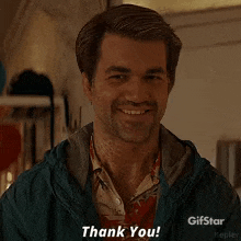 a man with a beard is smiling and says thank you .