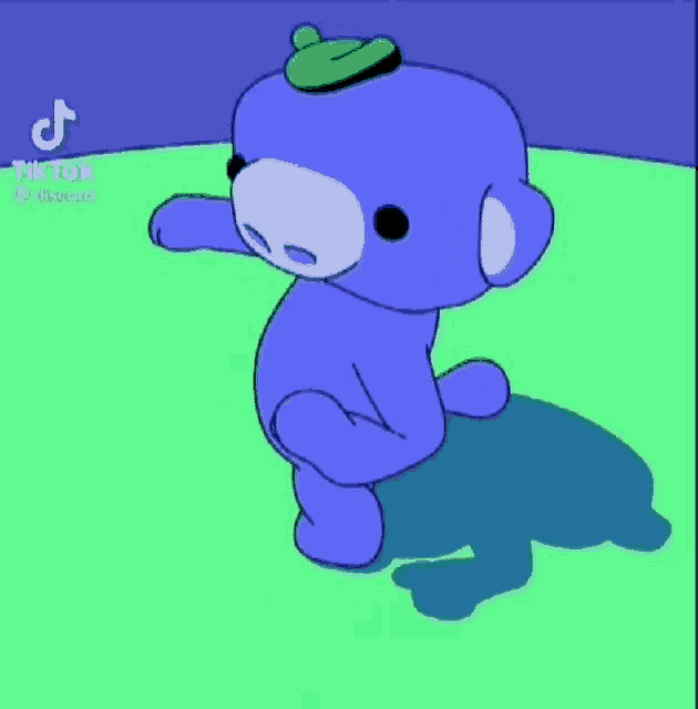 a blue cartoon character with a green hat on his head .