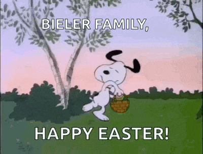 snoopy is carrying a basket of eggs in a field .