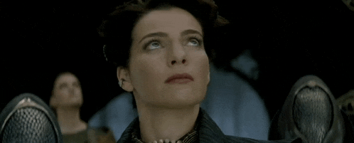 a close up of a woman 's face with her eyes closed in a dark room