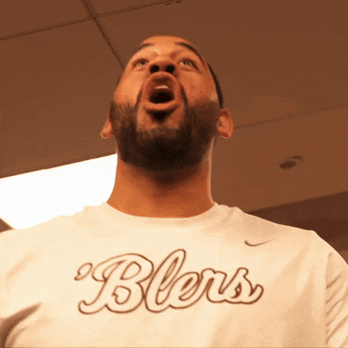 a man with a beard wears a shirt that says bless