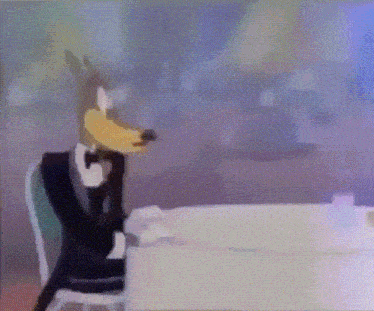 a wolf in a tuxedo sits at a table in a restaurant