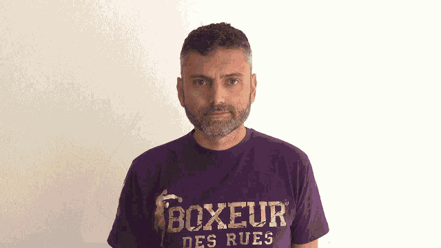 a man wearing a purple boxeur des rues t-shirt