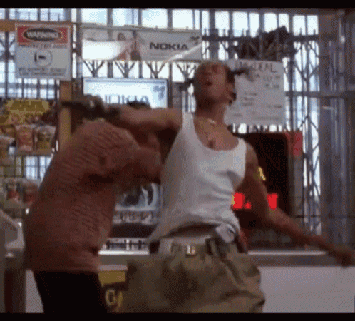 a man in a white tank top is standing in front of a sign that says nokia