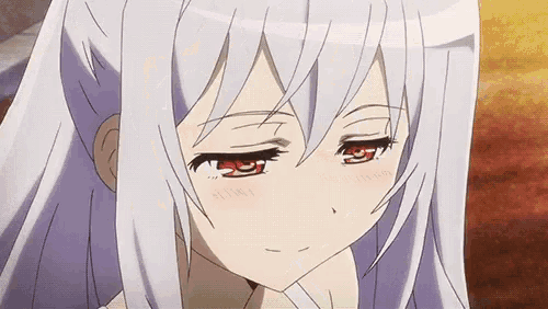 a close up of a girl 's face with white hair and red eyes .