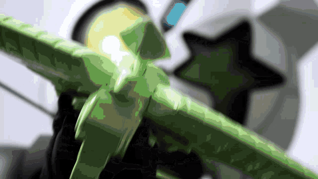a close up of a green toy with a star in the background