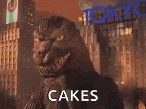 a monster is standing in the middle of a city with the words `` cakes '' written above it .