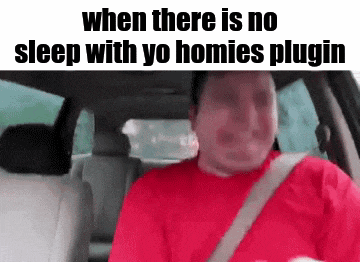 a man in a red shirt is sitting in the back seat of a car with a seat belt .