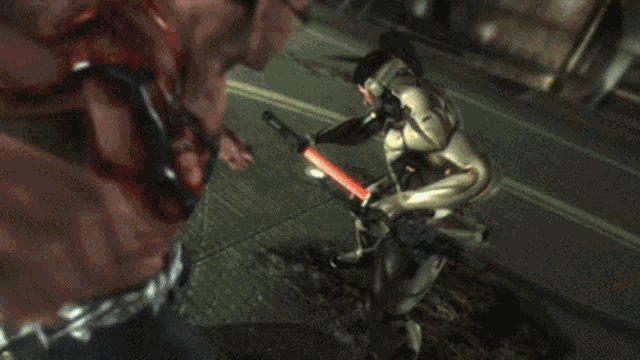 a close up of a robot 's arm with a red ribbon coming out of it