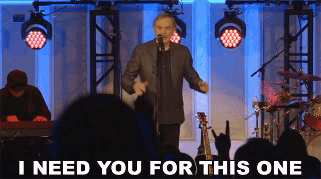 a man singing into a microphone with the words " i need you for this one " next to him