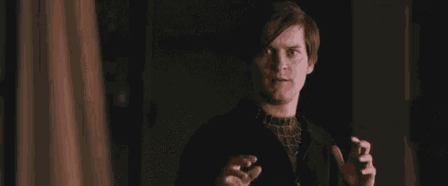 a man in a black jacket is making a funny face with his hands outstretched