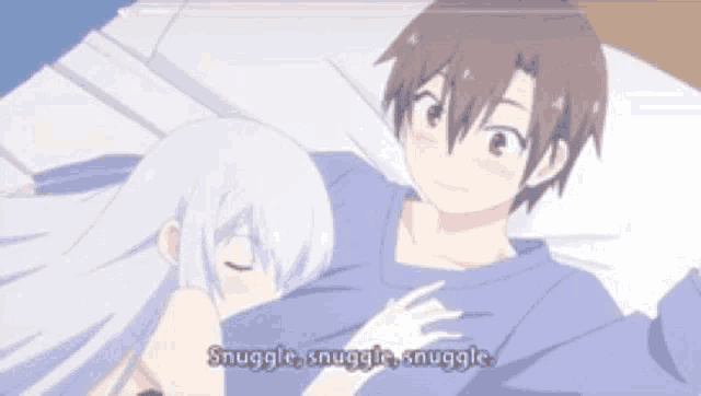 a boy and a girl are laying on a bed and the girl says snuggle snuggle snuggle .