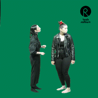 a group of people are standing in front of a green screen with the letter r in the corner