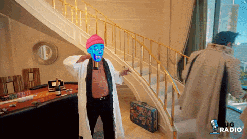 a man with a blue mask on his face is standing in front of a staircase and a sign that says ug radio