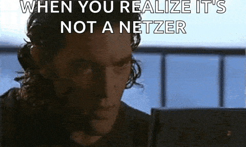 a man is looking at a laptop computer with a caption that says `` when you realize it 's not a netzer ''