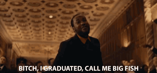 a man in a suit and red shirt says " bitch i graduated call me big fish "