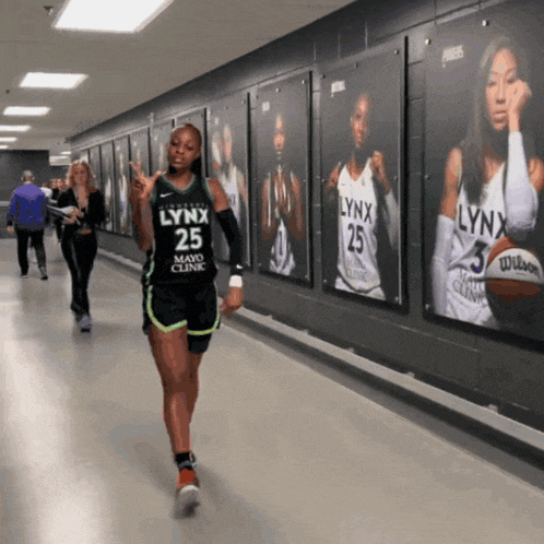 a lynx basketball player walks down a hallway