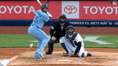 a baseball game is being played in front of toyota advertisements