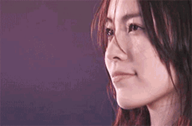 a close up of a woman 's face with her eyes closed