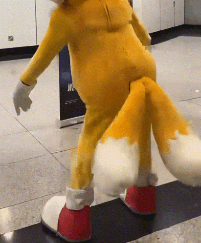 a fox mascot is standing on a tiled floor