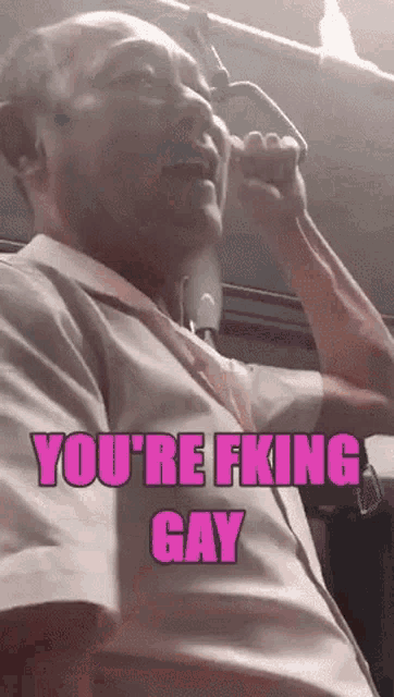 a man on a bus with the words you 're fking gay on the bottom