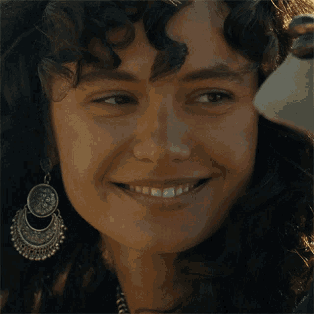a close up of a woman 's face with earrings