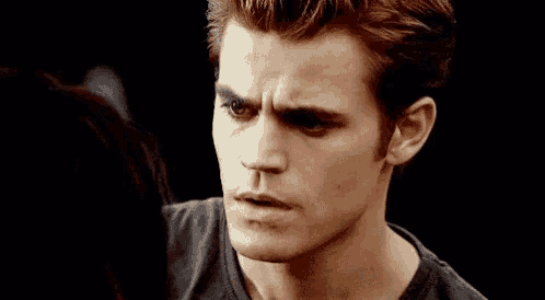 a close up of a man 's face with a woman behind him .