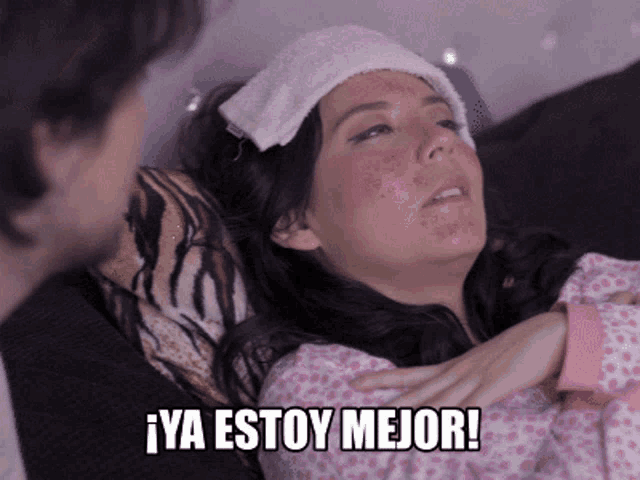 a woman with a towel on her head is laying on a couch and the caption says ya estoy mejor