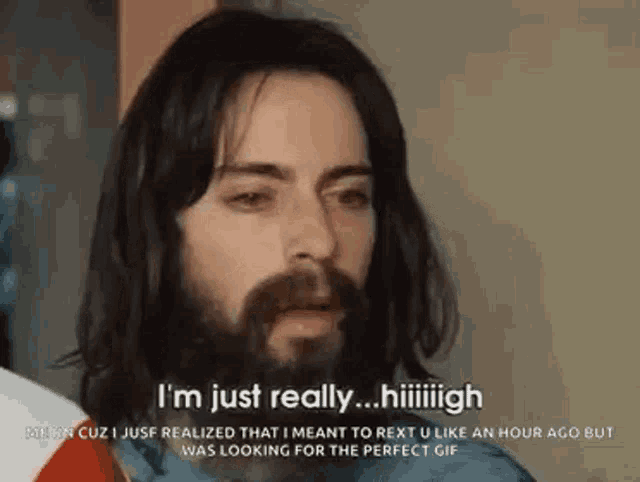 a man with long hair and a beard is talking about something .