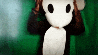 a person wearing a monkey costume covering their eyes