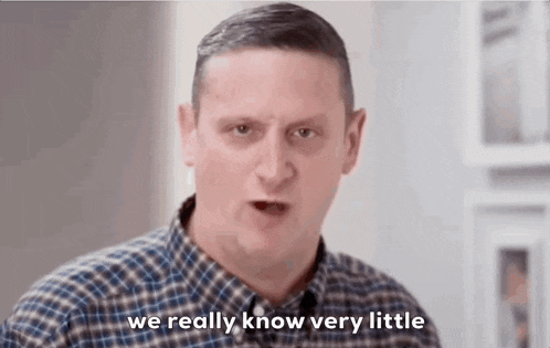 a man in a plaid shirt is talking to someone and saying `` we really know very little '' .