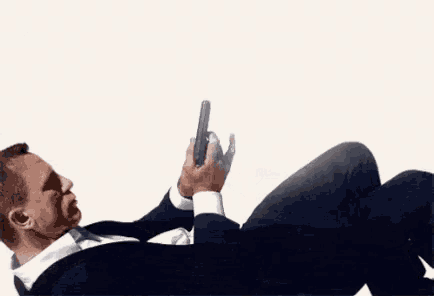 a man in a suit and tie is laying on the floor with the word fire above him
