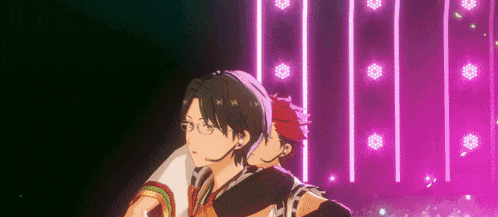 a couple of anime characters standing next to each other on a stage with purple lights behind them .