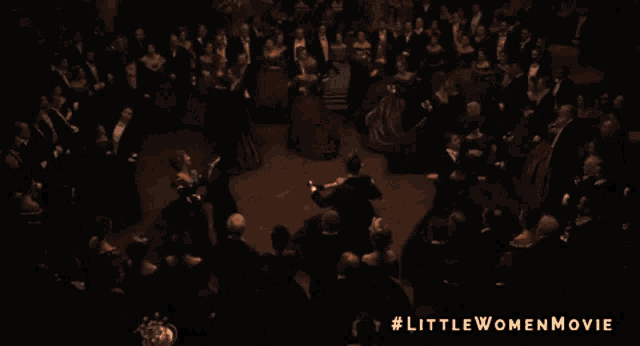 a man and a woman are dancing together in a ballroom in a little women movie .