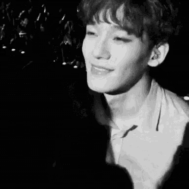 a black and white photo of a young man with his eyes closed .
